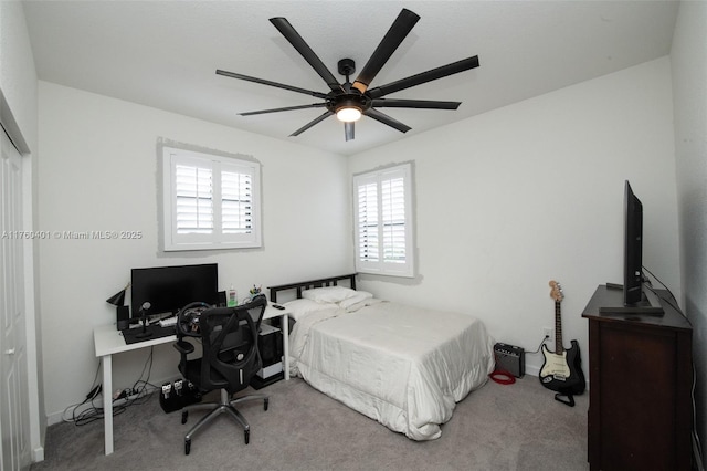 bedroom with a ceiling fan and carpet floors