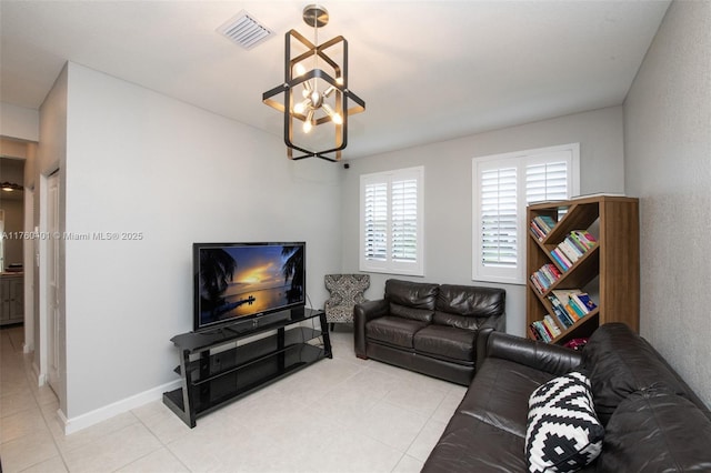 living room featuring light tile patterned flooring, visible vents, baseboards, and an inviting chandelier