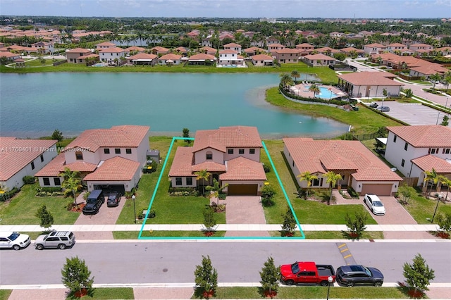 drone / aerial view with a residential view and a water view