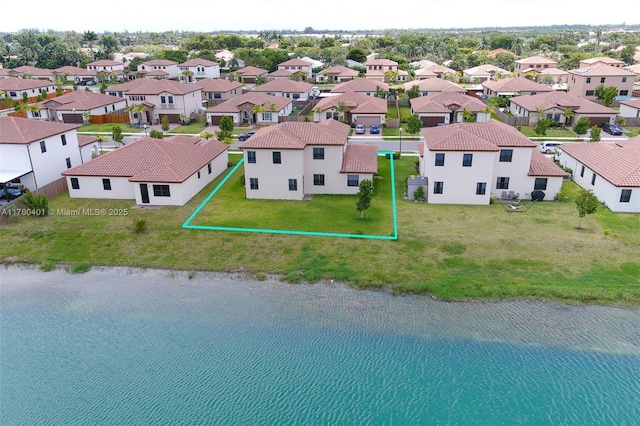 bird's eye view with a residential view and a water view