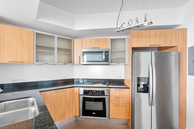 kitchen featuring modern cabinets, appliances with stainless steel finishes, and a sink