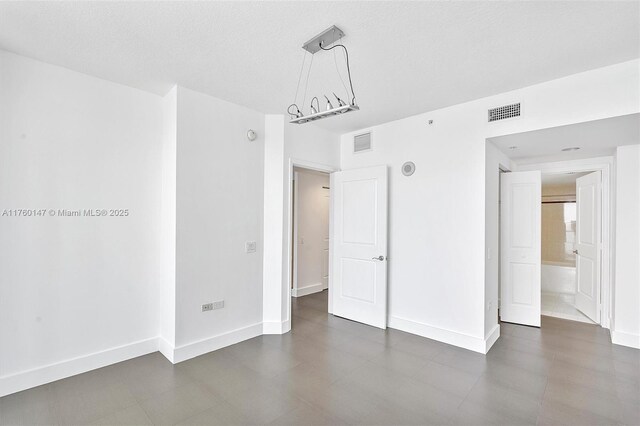 unfurnished bedroom with visible vents and baseboards