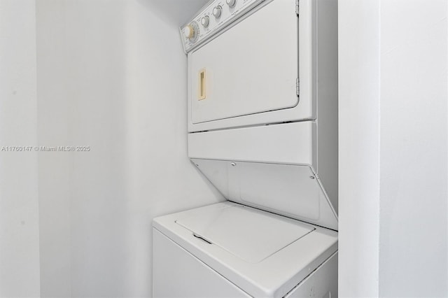 clothes washing area featuring laundry area and stacked washing maching and dryer