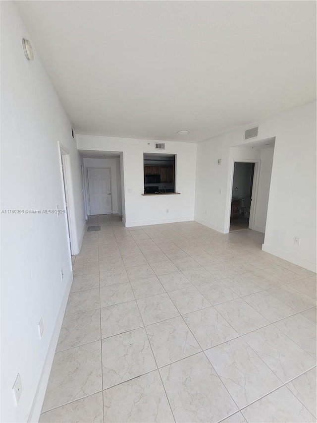 unfurnished living room with visible vents and baseboards