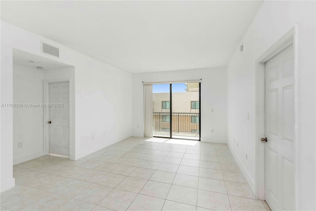 spare room featuring light tile patterned floors and visible vents