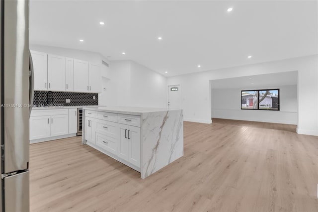 531 NE 175th Ter, North Miami Beach, FL 33162 - kitchen featuring freestanding refrigerator, beverage cooler, recessed lighting, light wood finished floors, and a kitchen island