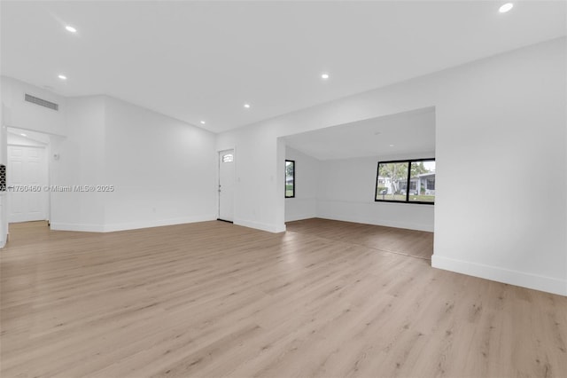 531 NE 175th Ter, North Miami Beach, FL 33162 - unfurnished living room featuring recessed lighting and light wood-style flooring