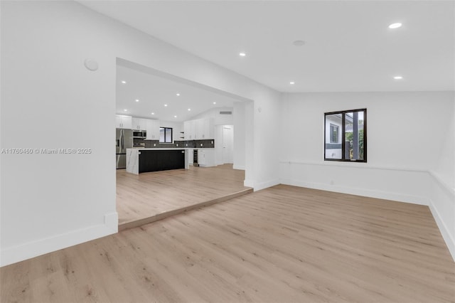 531 NE 175th Ter, North Miami Beach, FL 33162 - unfurnished living room featuring recessed lighting and light wood-type flooring