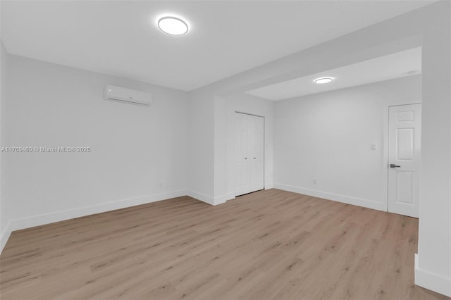 531 NE 175th Ter, North Miami Beach, FL 33162 - empty room with light wood finished floors and a wall mounted AC