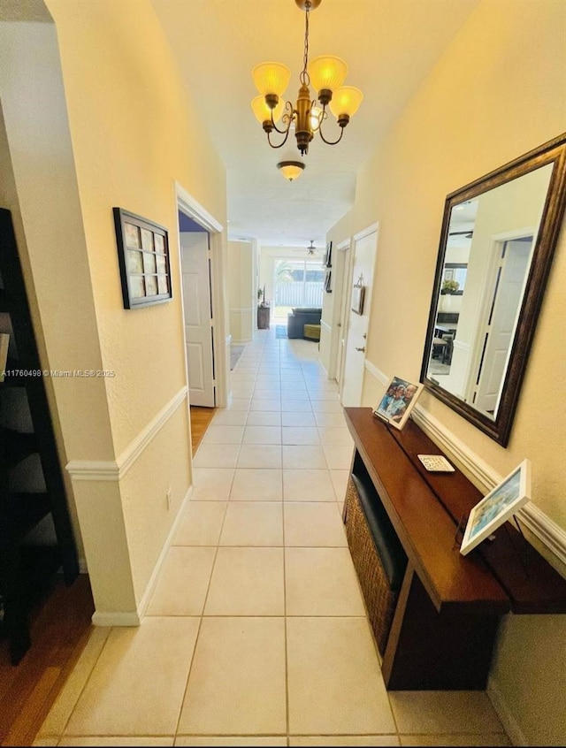 6938 NW 33rd St, Margate, FL 33063 - corridor with a chandelier, light tile patterned floors, and baseboards