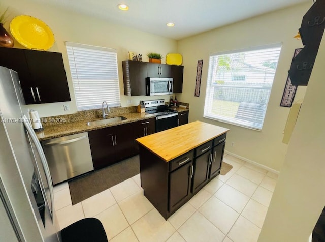 6938 NW 33rd St, Margate, FL 33063 - kitchen with appliances with stainless steel finishes, a sink, butcher block countertops, dark cabinets, and recessed lighting