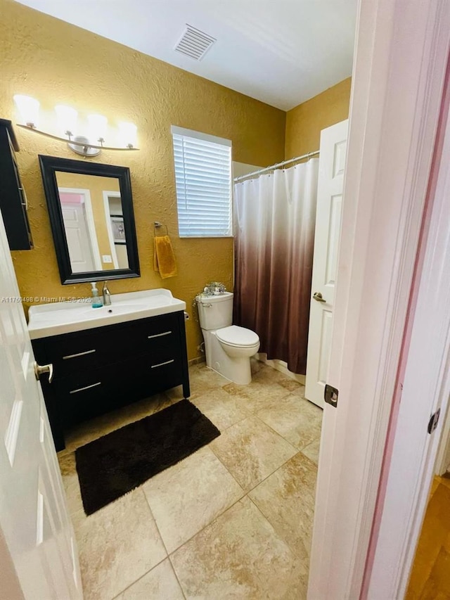 6938 NW 33rd St, Margate, FL 33063 - bathroom featuring a textured wall, toilet, vanity, tile patterned flooring, and a shower with curtain