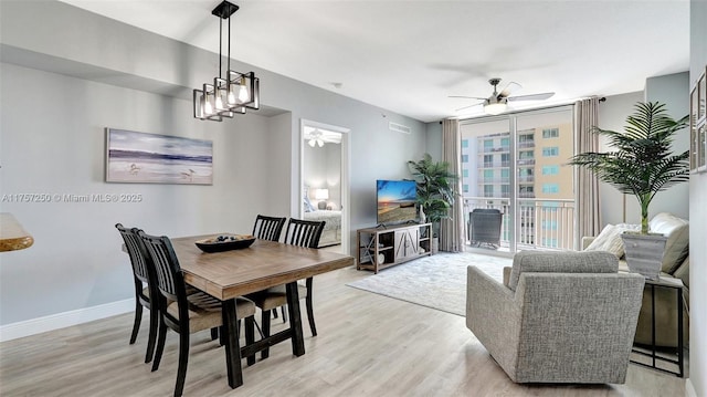 dining area featuring ceiling fan, baseboards, and light wood-style flooring