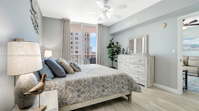 bedroom featuring visible vents, light wood-style flooring, a ceiling fan, and baseboards