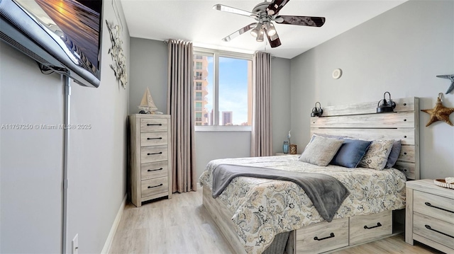 bedroom with baseboards, light wood-type flooring, and ceiling fan