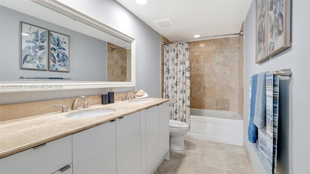 full bathroom featuring double vanity, toilet, shower / tub combo, and a sink