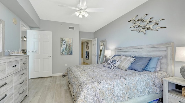 bedroom featuring visible vents, baseboards, light wood-style flooring, and a ceiling fan