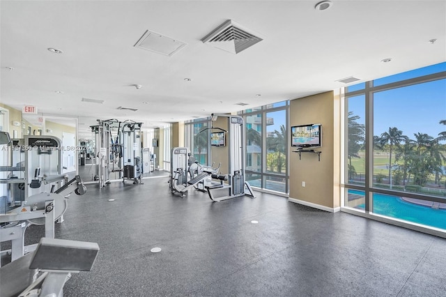 gym with visible vents, baseboards, and expansive windows