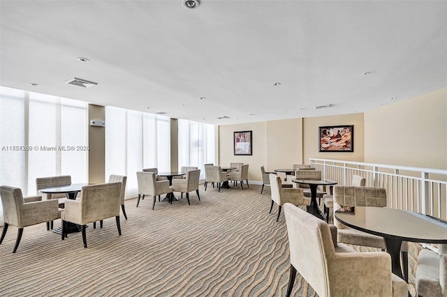 carpeted dining space with visible vents