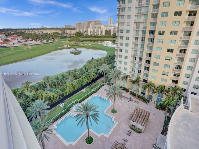 view of swimming pool with a city view and a water view