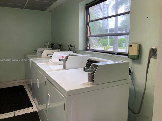 shared laundry area with light tile patterned floors and independent washer and dryer