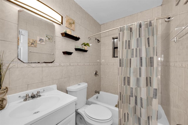 bathroom featuring toilet, vanity, tile walls, and shower / tub combo