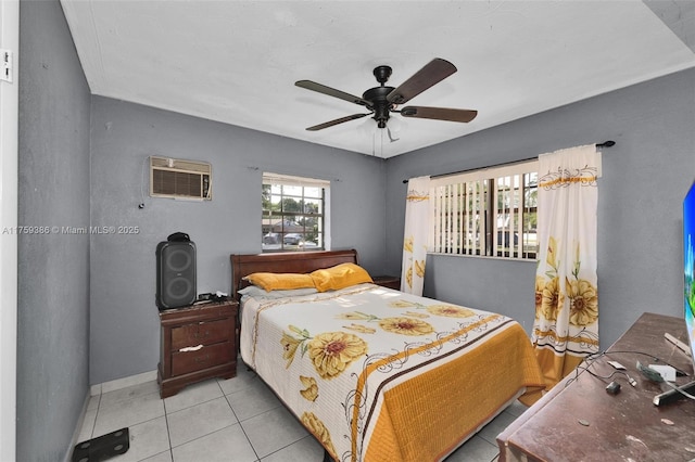 tiled bedroom featuring a wall mounted air conditioner and a ceiling fan