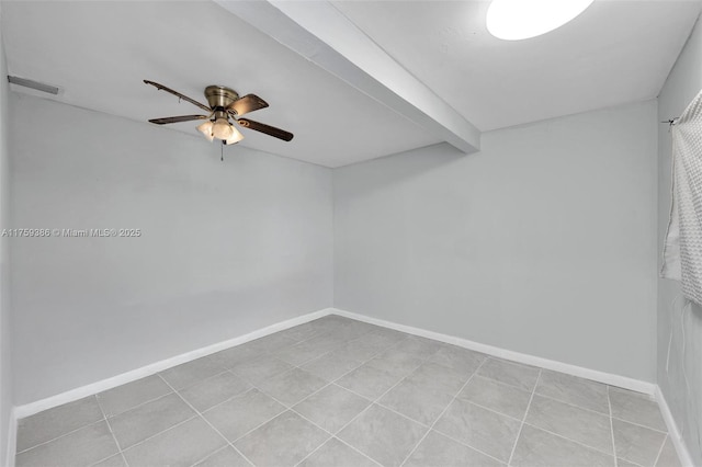 tiled spare room with beamed ceiling, a ceiling fan, and baseboards