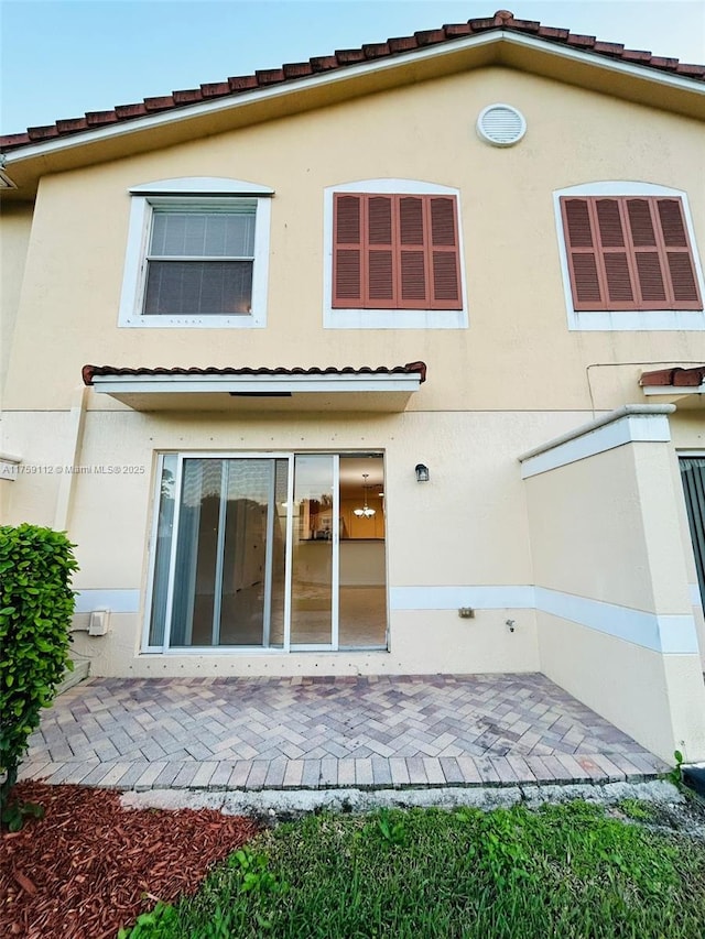 back of property with a patio area and stucco siding