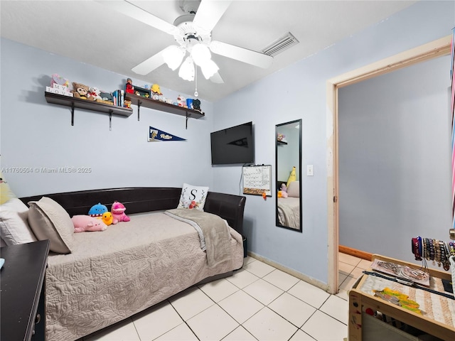 bedroom with light tile patterned floors, visible vents, baseboards, and ceiling fan