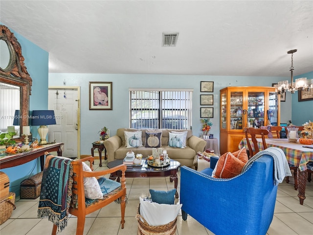 tiled living area with a wealth of natural light, visible vents, and a chandelier