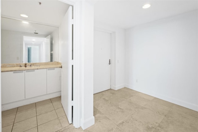 bathroom with tile patterned floors, recessed lighting, and vanity