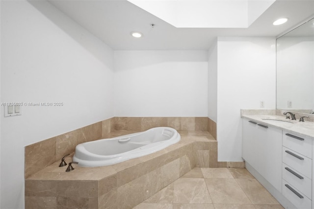 full bath featuring tile patterned floors, recessed lighting, a skylight, a bath, and vanity