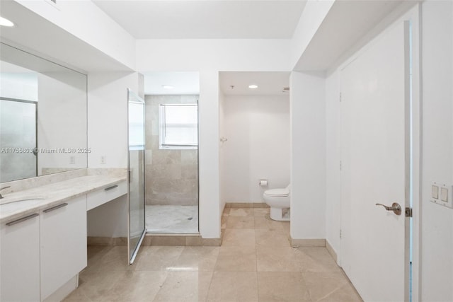 bathroom featuring vanity, baseboards, tile patterned flooring, a shower stall, and toilet