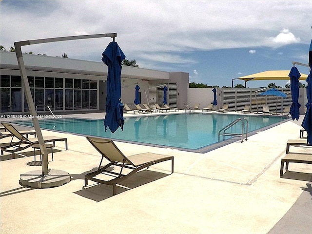 community pool featuring a patio area