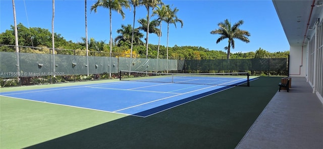 view of sport court featuring fence