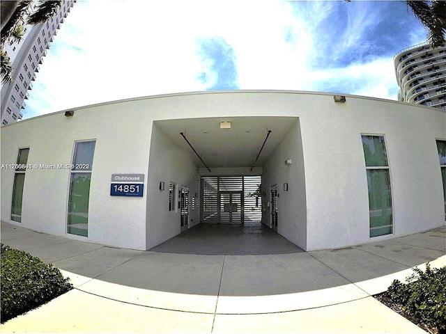 exterior space featuring an attached carport and driveway