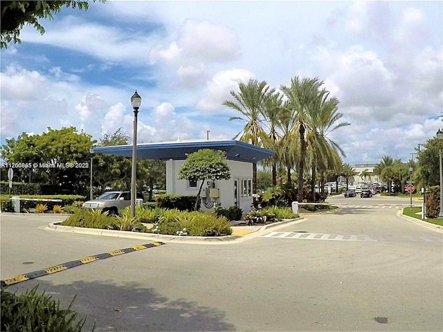 view of street with curbs, traffic signs, and street lights