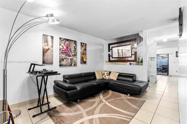 tiled living room featuring baseboards and a textured ceiling