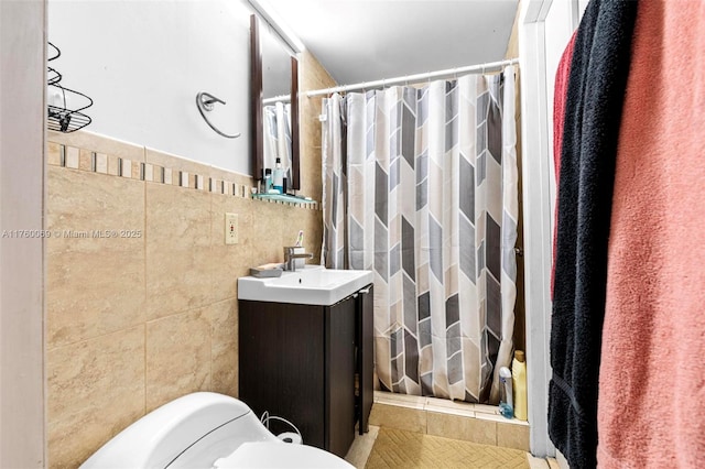 bathroom with curtained shower, tile walls, and vanity