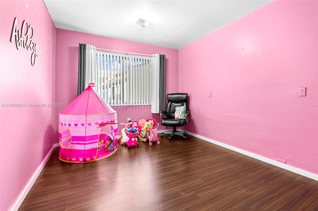 recreation room with wood finished floors and baseboards