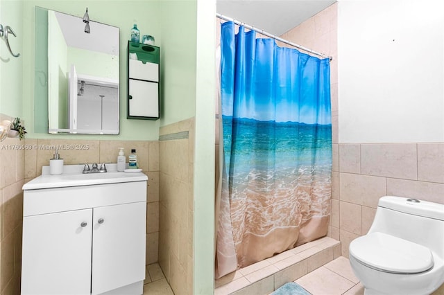 bathroom featuring vanity, a shower with curtain, a wainscoted wall, tile walls, and toilet