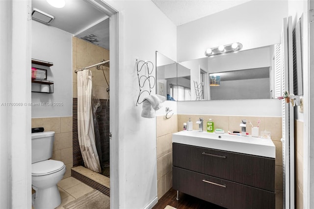 bathroom featuring vanity, visible vents, curtained shower, tile walls, and toilet