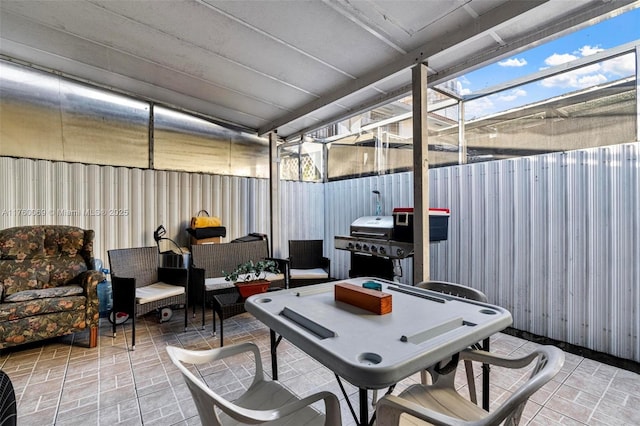 view of patio / terrace with a lanai, a grill, an outdoor hangout area, and a fenced backyard