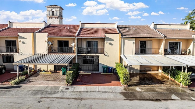 exterior space with stucco siding, a tiled roof, and a chimney