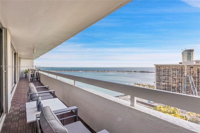 balcony featuring a water view