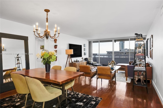 dining room featuring a wall of windows, dark wood-type flooring, and an inviting chandelier