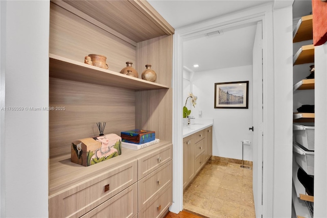 interior space featuring vanity and baseboards