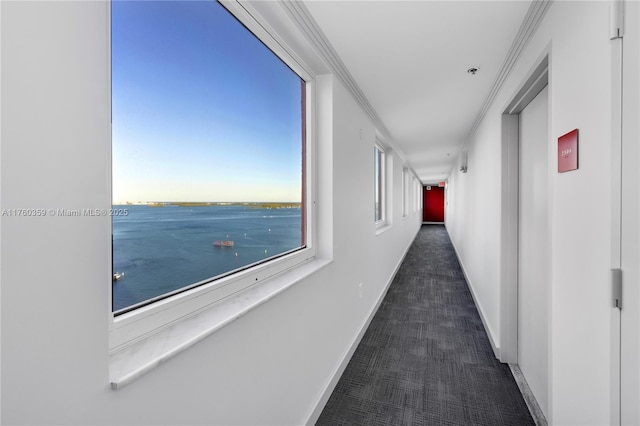 corridor with crown molding, carpet flooring, baseboards, and a water view