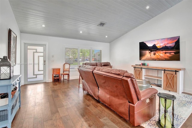 living area featuring baseboards, visible vents, lofted ceiling, hardwood / wood-style flooring, and wooden ceiling